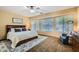 Relaxing main bedroom with large windows, a ceiling fan, and a comfortable king-size bed at 6350 S Four Peaks Pl, Chandler, AZ 85249