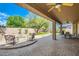 Covered patio features a built in fire-pit, dining and seating areas and beautiful backyard views at 6350 S Four Peaks Pl, Chandler, AZ 85249