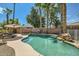 Inviting private pool surrounded by mature palm trees, creating a serene backyard oasis at 6350 S Four Peaks Pl, Chandler, AZ 85249