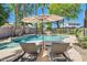 Relaxing backyard oasis featuring a pool, rock waterfall, and comfortable lounge chairs at 6350 S Four Peaks Pl, Chandler, AZ 85249