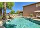 Sparkling backyard pool with rock waterfall feature and mature landscaping at 6350 S Four Peaks Pl, Chandler, AZ 85249