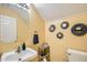 Charming powder room with modern fixtures, decorative mirrors and a stylish pedestal sink and commode at 6350 S Four Peaks Pl, Chandler, AZ 85249