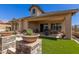 Beautiful outdoor patio with seating, a fire pit, and low-maintenance landscaping at 6912 E Quill St, Mesa, AZ 85207