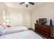 This is a warm bedroom with a tv and a pair of beds featuring coordinated bedding at 6912 E Quill St, Mesa, AZ 85207