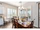 Elegant dining room with wood flooring, shuttered windows and natural light at 6912 E Quill St, Mesa, AZ 85207