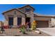 Charming single-story home with stone accents, desert landscaping, and a welcoming front porch at 6912 E Quill St, Mesa, AZ 85207