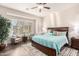 Inviting main bedroom with a king bed, neutral colors, plantation shutters, and ample natural light at 6912 E Quill St, Mesa, AZ 85207