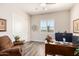 Functional office space with a ceiling fan, plantation shutters, and comfortable seating at 6912 E Quill St, Mesa, AZ 85207