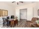 Functional office space with a ceiling fan, plantation shutters, and comfortable seating at 6912 E Quill St, Mesa, AZ 85207
