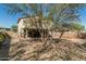 A large backyard landscaped with gravel and trees, with the house and patio in the background at 7090 S 252 Dr, Buckeye, AZ 85326