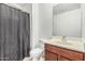 A functional bathroom featuring a vanity, mirror, toilet, and shower with a curtain at 7090 S 252 Dr, Buckeye, AZ 85326