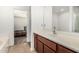 Bathroom featuring a vanity with wood cabinets and a view into the bedroom area at 7090 S 252 Dr, Buckeye, AZ 85326