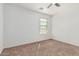 A simple bedroom with plush carpet and a window that lets in lots of natural light at 7090 S 252 Dr, Buckeye, AZ 85326