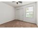 A spacious bedroom with soft carpeting, closet and window allowing natural sunlight at 7090 S 252 Dr, Buckeye, AZ 85326