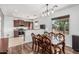 Stylish dining room with modern lighting fixture, wood floors, and view of stainless steel appliances at 7090 S 252 Dr, Buckeye, AZ 85326