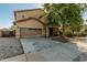 Inviting home exterior with a two-car garage, covered entry, and mature landscaping at 7090 S 252 Dr, Buckeye, AZ 85326