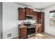 Kitchen featuring brown cabinetry, stainless steel appliances, and tile flooring at 7090 S 252 Dr, Buckeye, AZ 85326