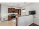 Cozy kitchen featuring brown cabinets, stainless steel appliances, and granite countertops at 7090 S 252 Dr, Buckeye, AZ 85326