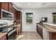 Bright kitchen featuring stainless steel appliances, brown cabinets and granite countertops at 7090 S 252 Dr, Buckeye, AZ 85326
