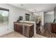 Well-appointed kitchenette featuring stainless steel appliances, granite countertops, and adjacent dining area at 7090 S 252 Dr, Buckeye, AZ 85326