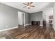 Spacious living area with wood flooring, ceiling fan, and neutral wall colors at 7090 S 252 Dr, Buckeye, AZ 85326