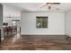 Bright, open-concept living area featuring wood floors and dining room in view at 7090 S 252 Dr, Buckeye, AZ 85326
