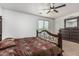 Bedroom showcasing carpet, a large window with blinds, and a dark wood bed frame at 7090 S 252 Dr, Buckeye, AZ 85326