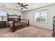 Spacious bedroom featuring carpet flooring, a ceiling fan, and a large window at 7090 S 252 Dr, Buckeye, AZ 85326