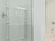 Bright bathroom with a glass-enclosed shower and a soaking tub in the background at 7090 S 252 Dr, Buckeye, AZ 85326