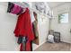 Organized walk-in closet with hanging clothes, shelving, and storage bins at 7090 S 252 Dr, Buckeye, AZ 85326