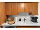Bright kitchen with a stainless-steel sink, white countertops and wood cabinets at 7350 N Via Paseo Del Sur -- # P105, Scottsdale, AZ 85258