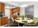 A kitchen and dining area with stainless steel appliances, wooden cabinets and modern art at 7350 N Via Paseo Del Sur -- # P105, Scottsdale, AZ 85258