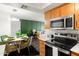 Bright living space with a modern dining table, sofa, and stainless-steel appliances at 7350 N Via Paseo Del Sur -- # P105, Scottsdale, AZ 85258