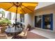 Outdoor patio with brick flooring, seating, and a large umbrella for shade at 7350 N Via Paseo Del Sur -- # P105, Scottsdale, AZ 85258