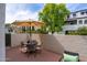Relaxing outdoor patio area with a dining table and umbrella, ideal for enjoying the outdoors at 7350 N Via Paseo Del Sur -- # P105, Scottsdale, AZ 85258
