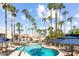 Resort-style community pool surrounded by lush palm trees and lounge chairs at 7350 N Via Paseo Del Sur -- # P105, Scottsdale, AZ 85258