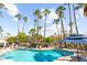 Inviting community pool area surrounded by lush palm trees and comfortable lounge chairs at 7350 N Via Paseo Del Sur -- # P105, Scottsdale, AZ 85258