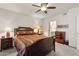 Comfortable bedroom with ceiling fan, a cozy bed, and an en-suite bathroom offers relaxation at 7575 E Indian Bend Rd # 1137, Scottsdale, AZ 85250