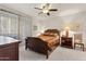 Well-lit bedroom featuring a wooden bed frame and a ceiling fan at 7575 E Indian Bend Rd # 1137, Scottsdale, AZ 85250