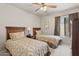 Bedroom with two twin beds, carpet, and ceiling fan; perfect for relaxation and rest at 7575 E Indian Bend Rd # 1137, Scottsdale, AZ 85250