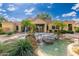 Community clubhouse with a water feature, palm trees, and tile roof, perfect for relaxation and social gatherings at 7575 E Indian Bend Rd # 1137, Scottsdale, AZ 85250