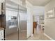 Modern kitchen featuring stainless steel refrigerator and ample storage, seamlessly connected to the living space at 7575 E Indian Bend Rd # 1137, Scottsdale, AZ 85250