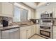 Updated kitchen with stainless steel appliances, tile backsplash, and a window for natural light at 7575 E Indian Bend Rd # 1137, Scottsdale, AZ 85250