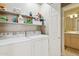 Practical laundry room with washer, dryer, and shelving units offering efficient organization at 7575 E Indian Bend Rd # 1137, Scottsdale, AZ 85250