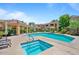 Community pool and hot tub area surrounded by lush landscaping, lounge chairs, and umbrellas, offering a serene retreat at 7575 E Indian Bend Rd # 1137, Scottsdale, AZ 85250