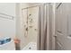 Walk-in shower with tile surround, shelving, and modern fixtures for a spa-like experience at 7575 E Indian Bend Rd # 1137, Scottsdale, AZ 85250