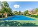 Bright community tennis court with mature shade trees in the background adding a sense of beauty and privacy at 7575 E Indian Bend Rd # 1137, Scottsdale, AZ 85250