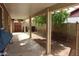 View of the covered back patio with beige beams and posts, as well as a view of the yard at 7608 W Mescal St, Peoria, AZ 85345