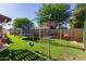 Lush backyard with trampoline and colorful play equipment at 7608 W Mescal St, Peoria, AZ 85345