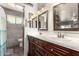 Bathroom featuring double sinks and vanity, with a tile shower at 7608 W Mescal St, Peoria, AZ 85345